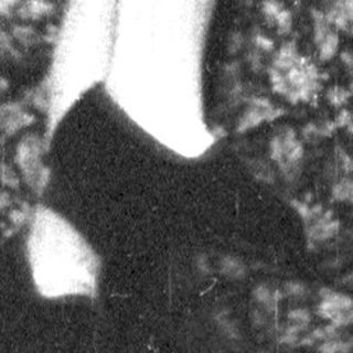 A person in vintage clothing holding a child.
