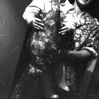 A child hugging a large cat indoors.
