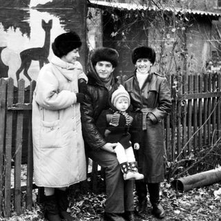 Family posing outdoors in winter clothing.