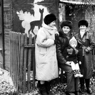 Family posing outdoors in winter clothing.