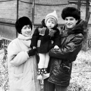 Family portrait in winter clothing outdoors.