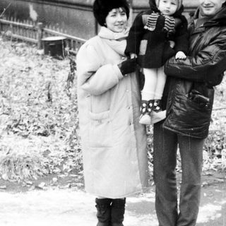 Family portrait in winter clothing outdoors.