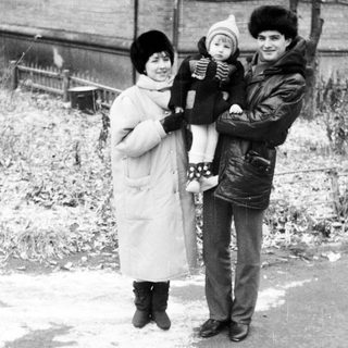 Family portrait in winter clothing outdoors.