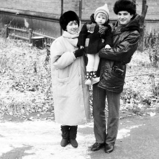 Family portrait in winter clothing outdoors.