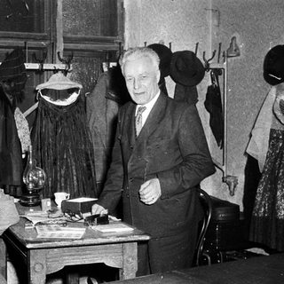 Vintage clothing shop with man and woman posing.
