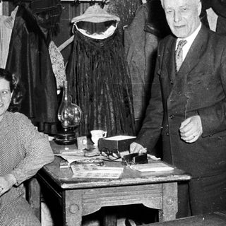 Vintage clothing shop with man and woman posing.
