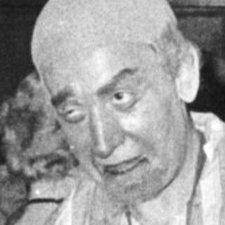 Man in striped concentration camp attire at event.