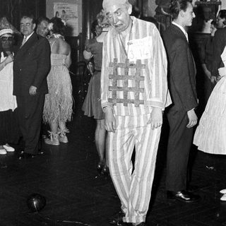 Man in striped concentration camp attire at event.