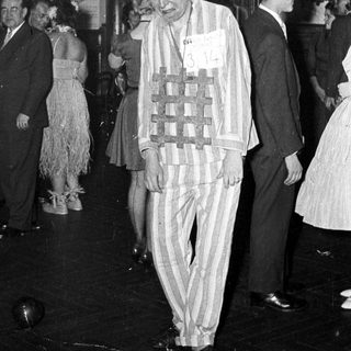 Man in striped concentration camp attire at event.