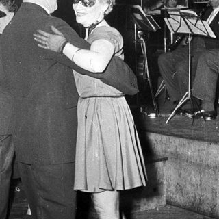 Couple dancing at a formal event.