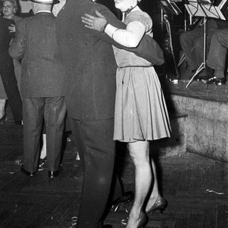 Couple dancing at a formal event.