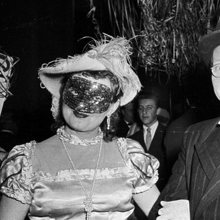 Costumed couple at formal evening event.