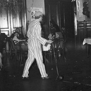 Man in striped pajamas performing on stage.