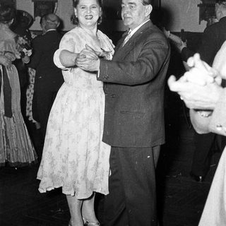 Couple dancing at a formal event.