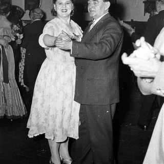 Couple dancing at a formal event.