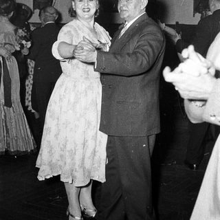 Couple dancing at a formal event.
