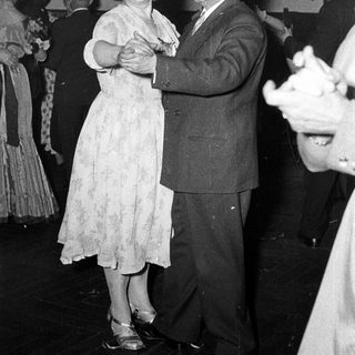 Couple dancing at a formal event.