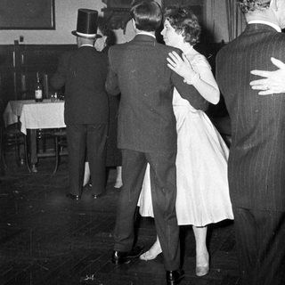 People dancing at a formal evening event.