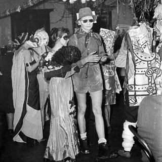 Costumed group at a festive indoor event.