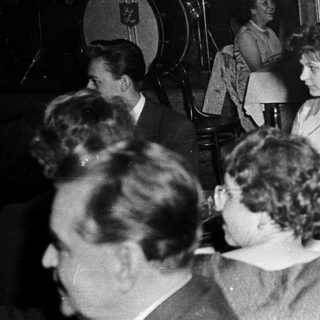 Social gathering with live music and seated guests.