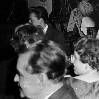 Social gathering with live music and seated guests.