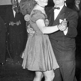Couple dancing at a formal evening event.