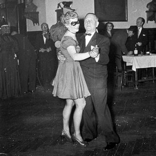 Couple dancing at a formal evening event.