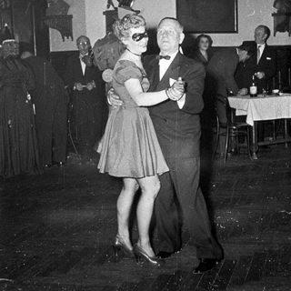 Couple dancing at a formal evening event.