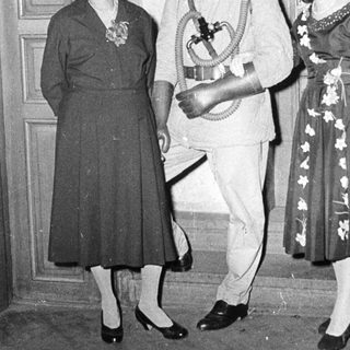 Formal attire from mid-20th century event.