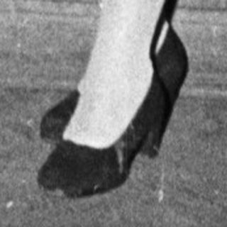 Formal attire from mid-20th century event.