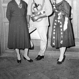 Formal attire from mid-20th century event.