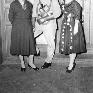 Formal attire from mid-20th century event.
