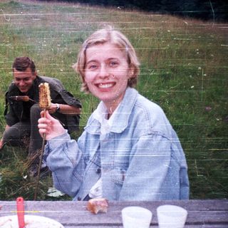 People enjoying outdoor picnic with food.