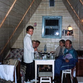 Cozy indoor gathering in a triangular attic space.