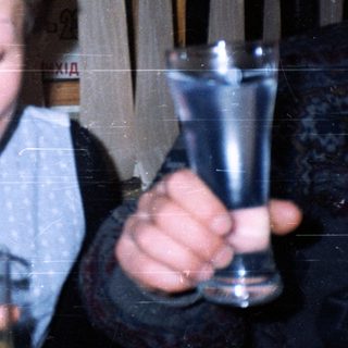 Boy drinking through a straw indoors.