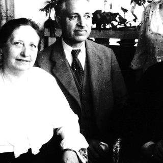 Four individuals posing indoors, mid-20th century.