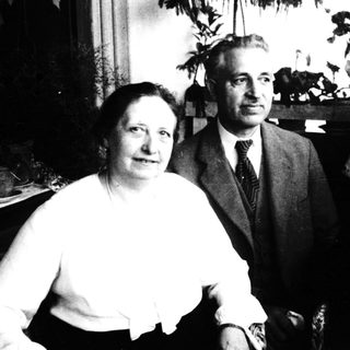 Four individuals posing indoors, mid-20th century.