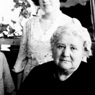 Four elderly individuals posing indoors together.