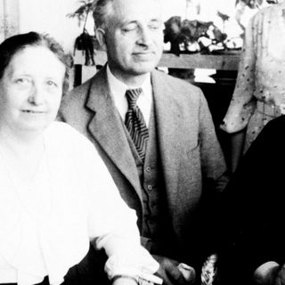 Four elderly individuals posing indoors together.