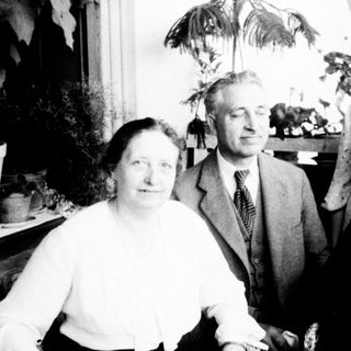 Four elderly individuals posing indoors together.