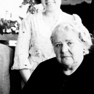 Family portrait from mid-20th century indoors.