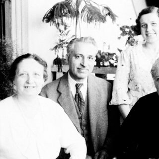 Family portrait from mid-20th century indoors.