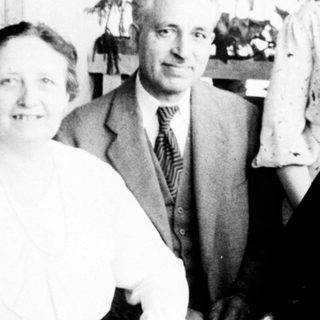 Family portrait from mid-20th century indoors.