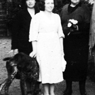 Family portrait with dog, mid-20th century.