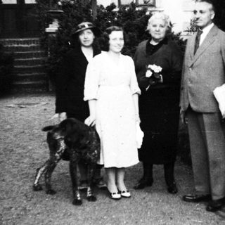 Family portrait with dog, mid-20th century.