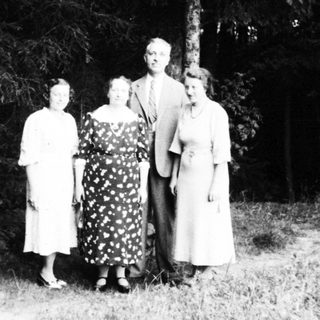 Family portrait in outdoor woodland setting.