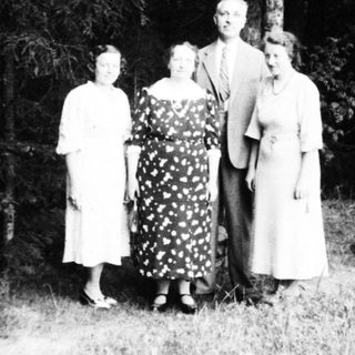Family portrait in outdoor woodland setting.