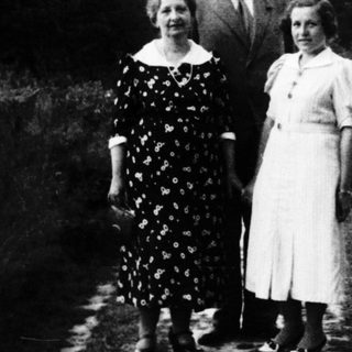 Family portrait outdoors in vintage clothing, early 20th century.
