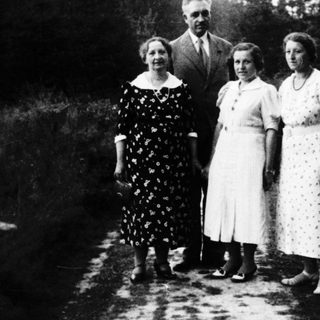Family portrait outdoors in vintage clothing, early 20th century.