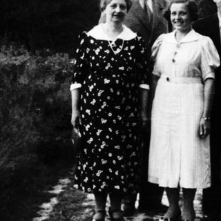 Family portrait outdoors in early 20th-century clothing.